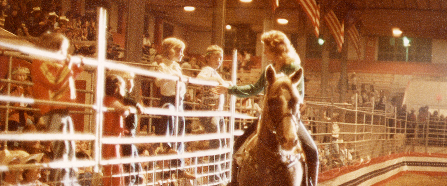 Reba on horse talks to children in the audience 